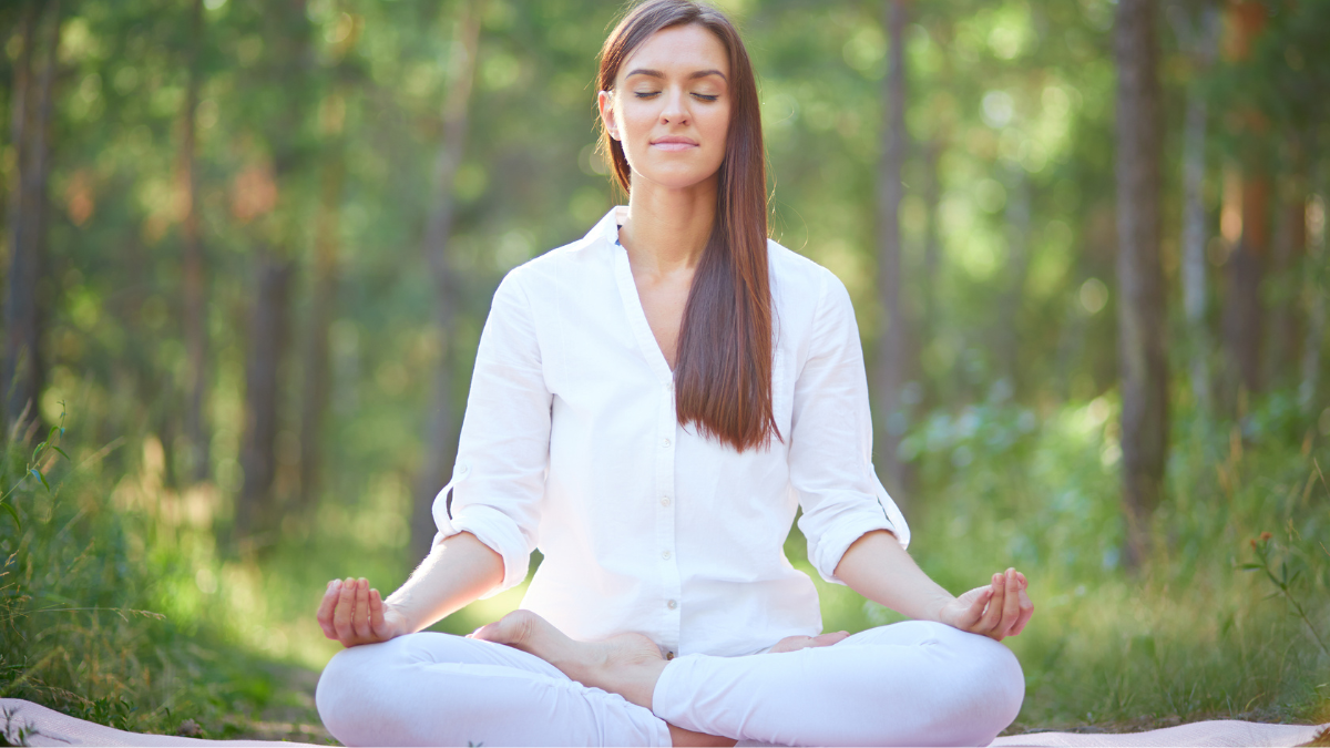 "A serene image of a woman practicing yoga amidst tranquil surroundings, embodying stress management, self-care, and the balance necessary for building emotional resilience."